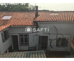 Casa adosada con huerta.